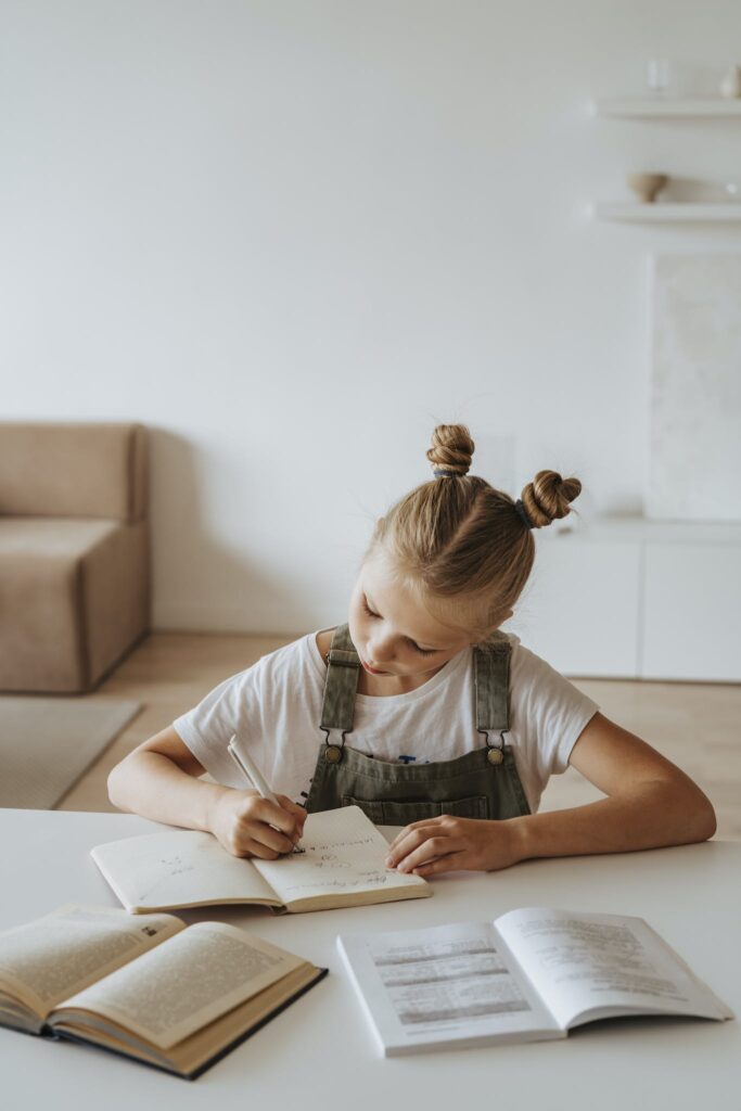 Little Girl Writing on a Notebook